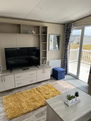 a living room with a large flat screen tv at Sea Breeze Escape in Cubert