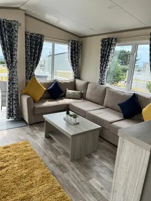 a living room with a couch and a coffee table at Sea Breeze Escape in Cubert