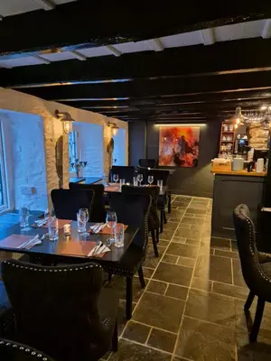a restaurant with tables and chairs in a room at OXOX - Room Only Accommodation in Polperro