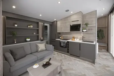 a living room with a couch and a kitchen at St. Ives Holiday Village in St Ives