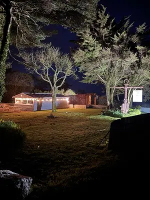 a house with lights in a yard at night at The Balnoon Inn B&B in St Ives