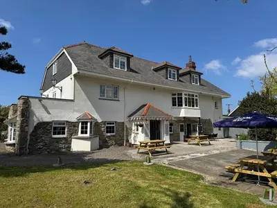 a large house with picnic tables in front of it at The Balnoon Inn B&B in St Ives