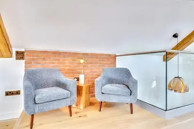 two chairs in a room with a brick wall at Keynvor View in Port Isaac