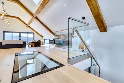 a glass elevator in a living room with a couch at Keynvor View in Port Isaac