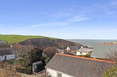 a town with houses and the ocean in the background at Keynvor View in Port Isaac