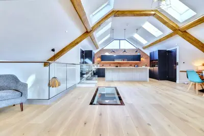 an open living room with skylights and a glass table at Keynvor View in Port Isaac