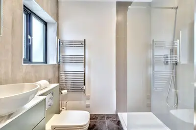 a white bathroom with a sink and a toilet at Keynvor View in Port Isaac