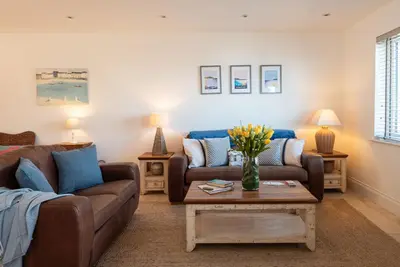 a living room with two couches and a coffee table at Seaspray in Port Isaac