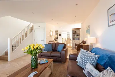 a living room with a couch and a table at Seaspray in Port Isaac