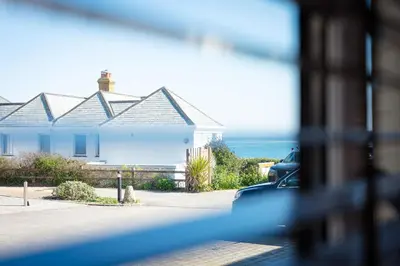 a white house with a view of the ocean at Seaspray in Port Isaac