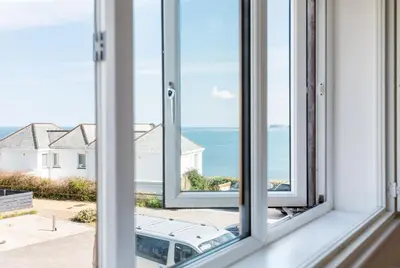 an open window with a view of the ocean at Seaspray in Port Isaac