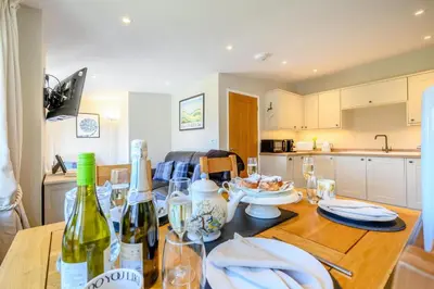 a kitchen with a wooden table with wine bottles on it at 2 Bed in Altarnun oc-t31858 in Altarnun