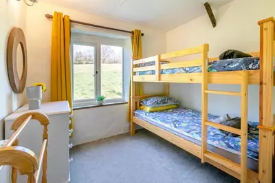 two bunk beds in a room with a window at 2 Bed in Duloe oc-f31903 in Duloe