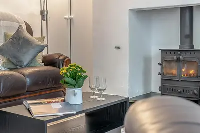 a living room with a couch and a wood stove at 2 Bed in Pensilva oc-z31812 in Middlehill