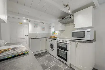 a kitchen with white cabinets and a microwave at 2 Bed in Pensilva oc-z31812 in Middlehill