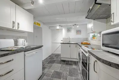 a large white kitchen with white cabinets and appliances at 2 Bed in Pensilva oc-z31812 in Middlehill