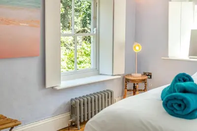 a bedroom with a bed and a window at 3 Bed in St. Teath oc-r31945 in Saint Teath