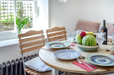 a wooden table with a bowl of fruit on it at 3 Bed in St. Teath oc-r31945 in Saint Teath
