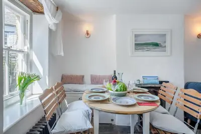 a dining room with a wooden table and chairs at 3 Bed in St. Teath oc-r31945 in Saint Teath