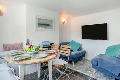 a living room with a table and a tv at 3 Bed in St. Teath oc-r31945 in Saint Teath