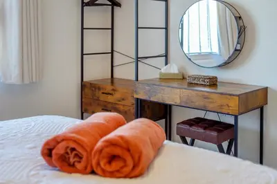 a bedroom with a desk and a bed with towels at 1 Bed in Summercourt oc-b31829 in Saint Enoder