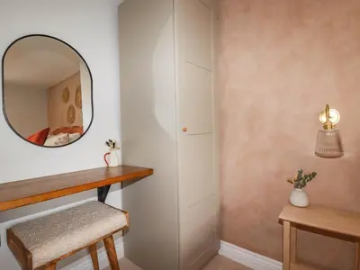 a dressing room with a mirror and a stool at Rock View in St Austell