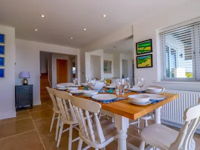 a dining room with a wooden table and chairs at The Old Harbour Masters House in Fowey