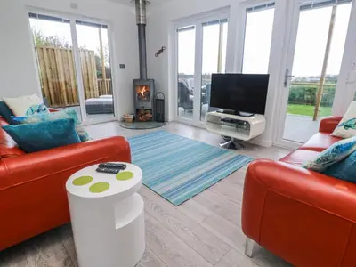 a living room with two couches and a tv at Petroc in Redruth