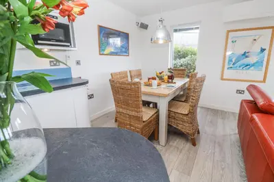 a kitchen and dining room with a table and chairs at Petroc in Redruth