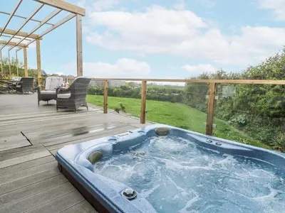 a jacuzzi tub on a wooden deck at Petroc in Redruth
