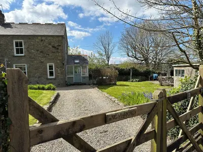 a wooden fence in front of a house at Little Nampara Cottage in Portreath