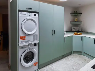 a kitchen with a washer and dryer in a kitchen at The Pines in Redruth