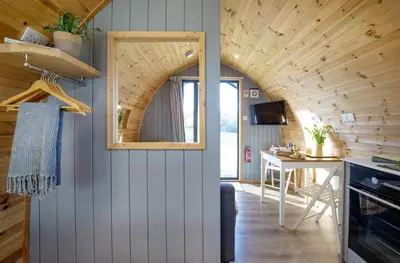 a kitchen and dining room in a tiny house at Demelza in Liskeard