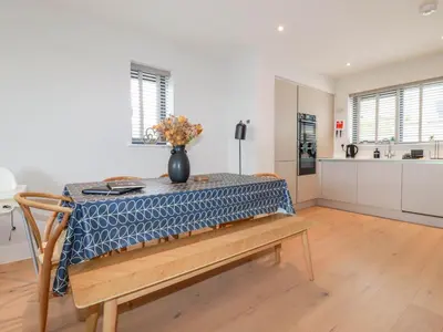 a kitchen with a table with a vase on it at Ebbtide in Newquay