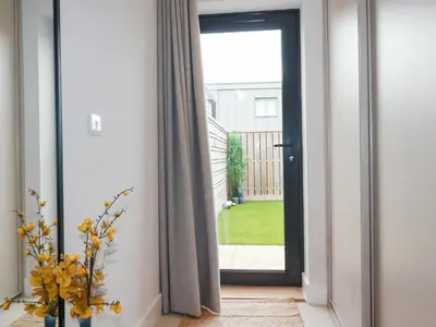 a hallway with a door leading to a yard at Ebbtide in Newquay