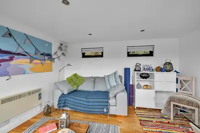 a living room with a couch and a table at Finest Retreats - Garden Cottage in Fowey in Fowey
