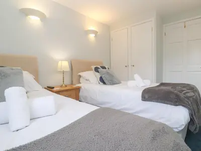 two beds sitting next to each other in a bedroom at Tobys Quay in Falmouth