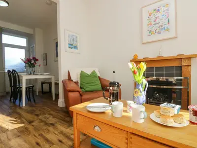 a living room with a table and a couch at Breakers Point in St Ives
