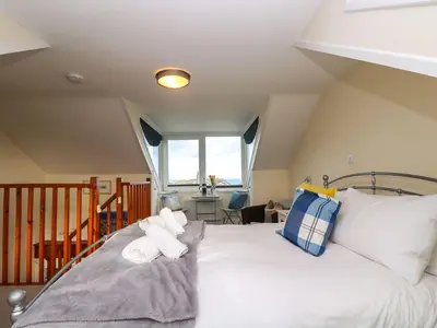 a bedroom with a bed with towels on it at Breakers Point in St Ives