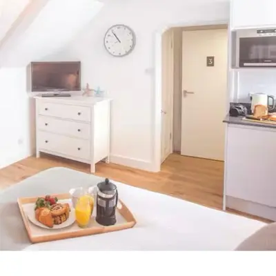 a kitchen with a tray of food and orange juice at Attic in St Ives