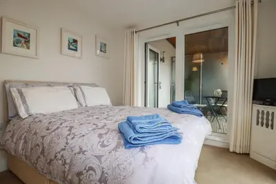 a bedroom with a bed with towels on it at 13 Clock Tower Court in St Austell