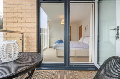 a room with a glass door leading to a bedroom at 13 Clock Tower Court in St Austell