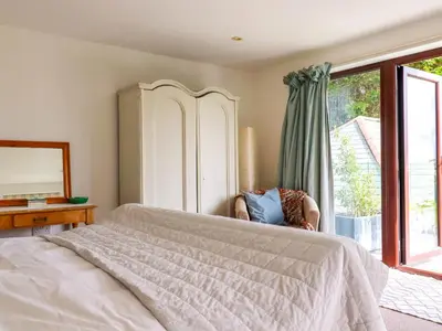 a bedroom with a large bed and a window at Goatsland in Wadebridge
