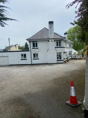 a white house with a cone in front of it at Cornerways Guest House St Austell Cornwall in St Austell