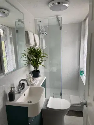 a bathroom with a toilet and a sink and a shower at Cornerways Guest House St Austell Cornwall in St Austell