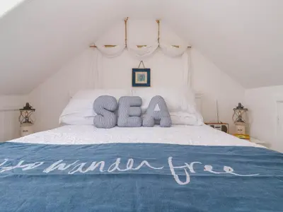 a bed with a sign that says sea on it at Seahorse Cottage in St Ives
