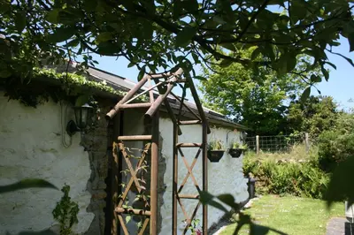 an old wooden gate in the side of a building at 2 bed barn on smallholding in Stithians