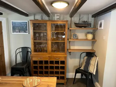 a room with a wooden cabinet filled with glasses at Character 3 Bed Cottage, Close to Waters edge, Parking in Looe