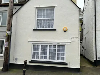a white house with a large window on a street at Character 3 Bed Cottage, Close to Waters edge, Parking in Looe