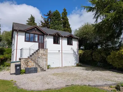 a white house with a white garage at Near Eden Project apartment in Trethurgy